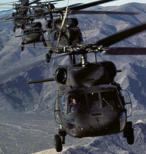 UH-60A Black Hawk string flies over mountains 